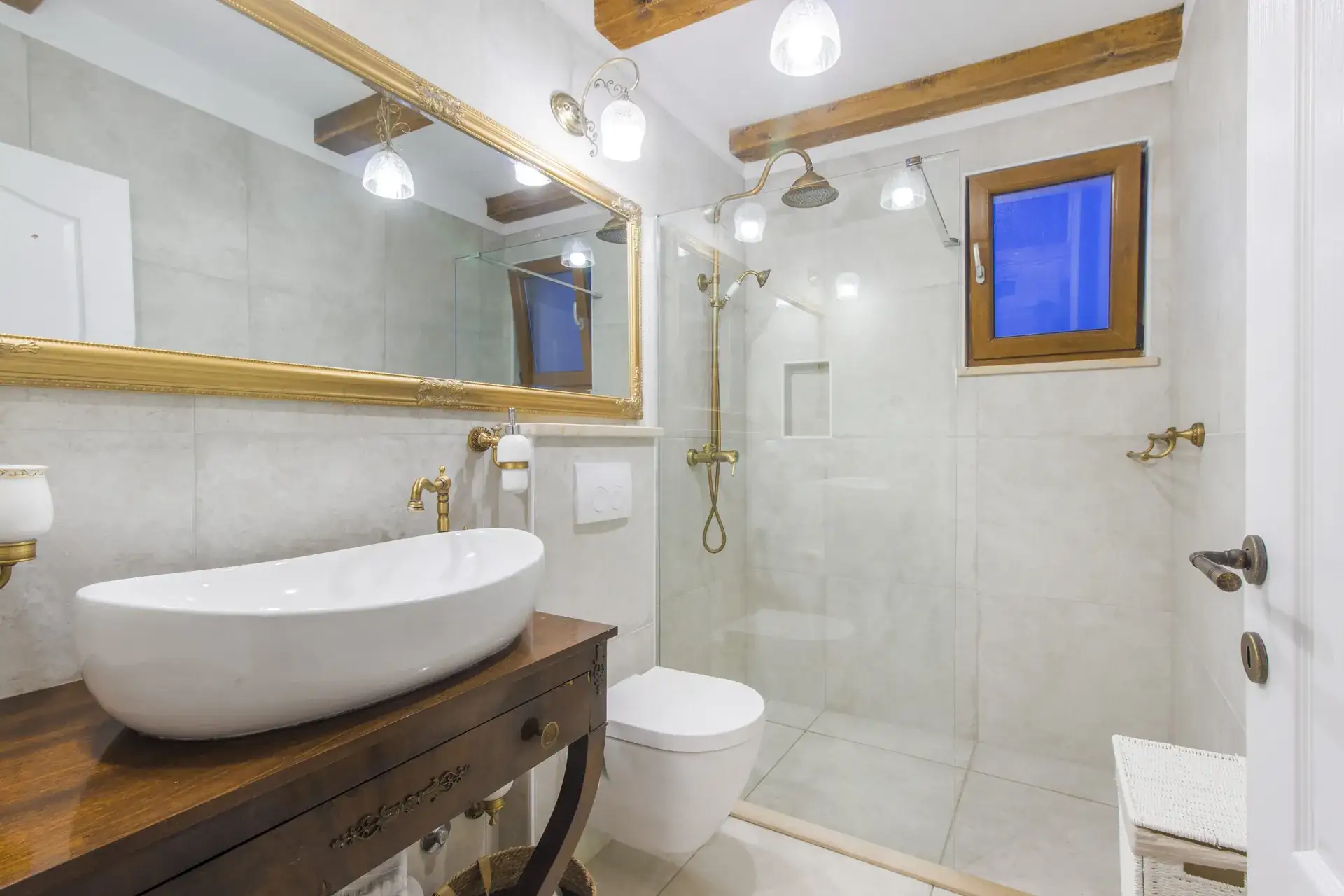 Bathroom with a vessel sink on a wooden counter and a walk-in shower