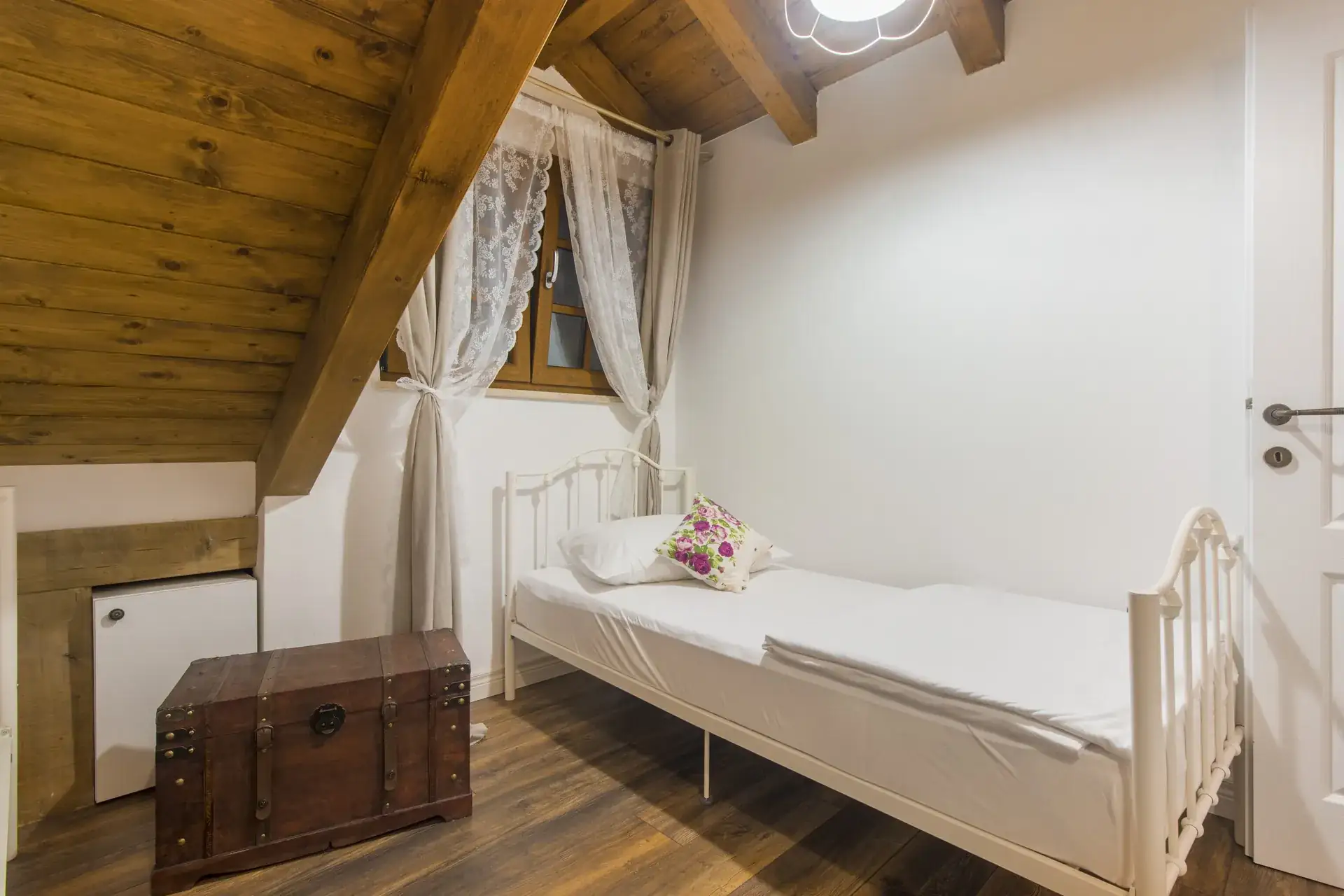 Single bed and wooden storage chest in the third bedroom