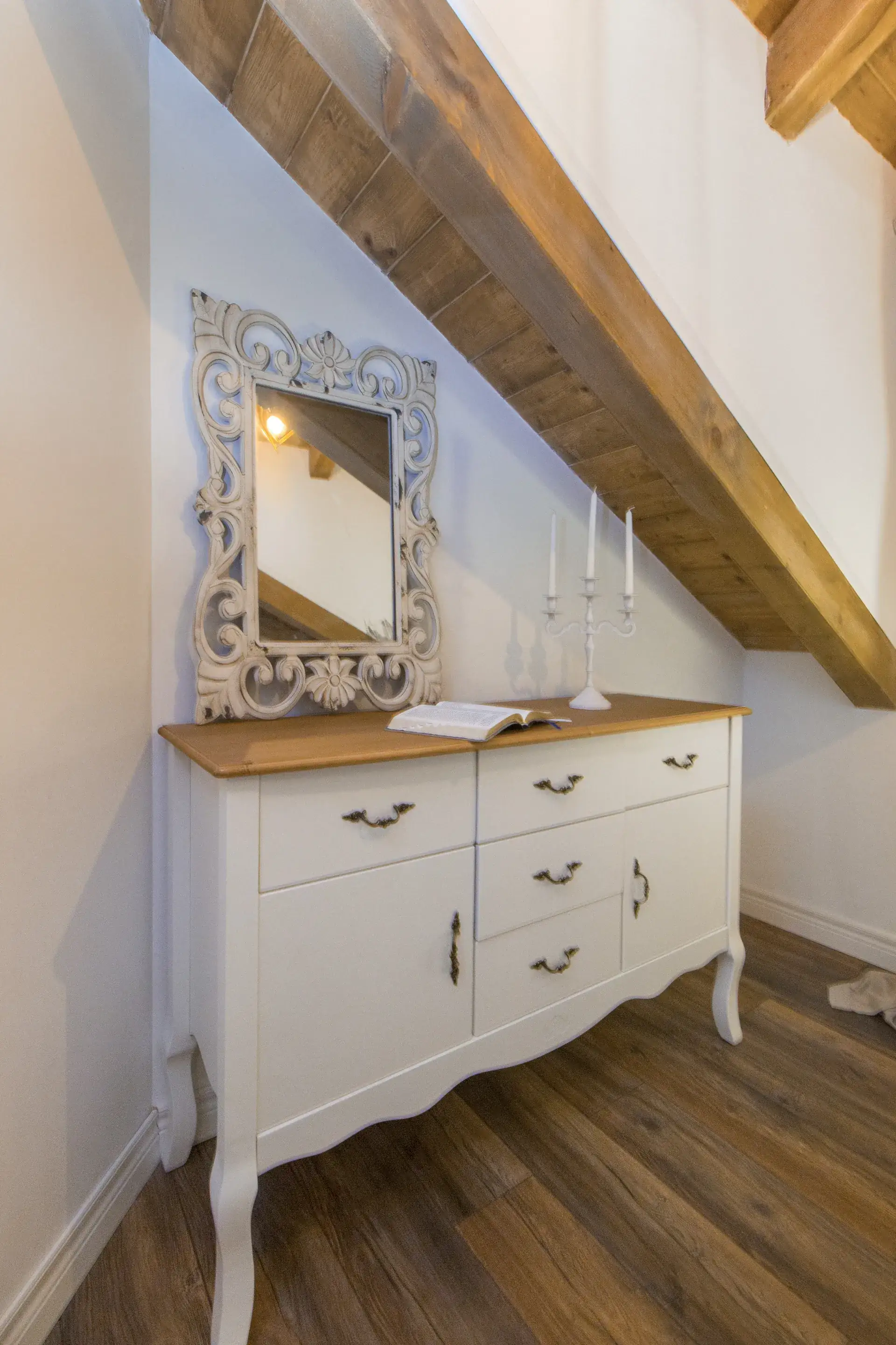 Dresser with a carved mirror on the bedroom landing