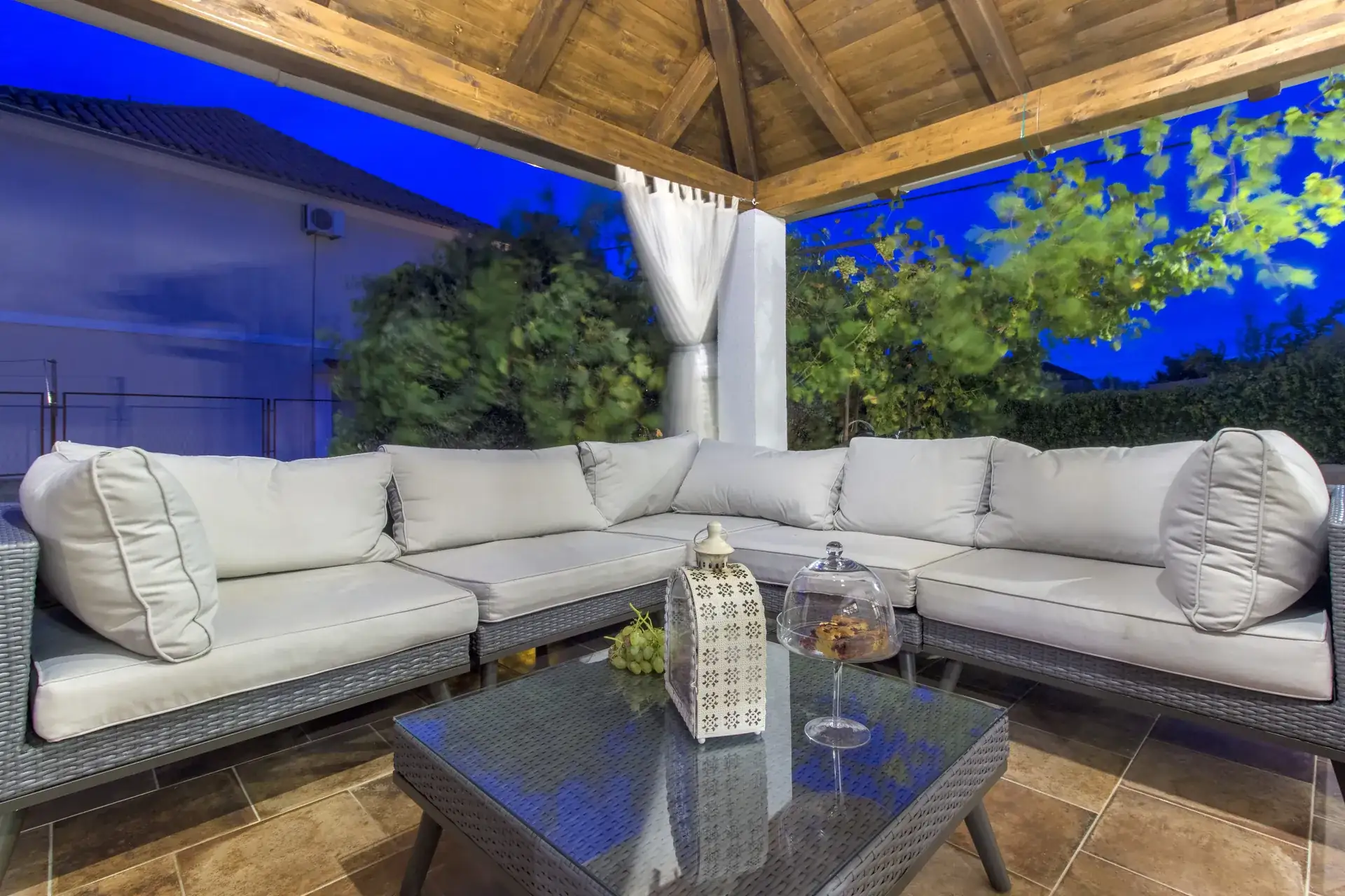 Terrace lounge and coffee table in the blue light of the evening