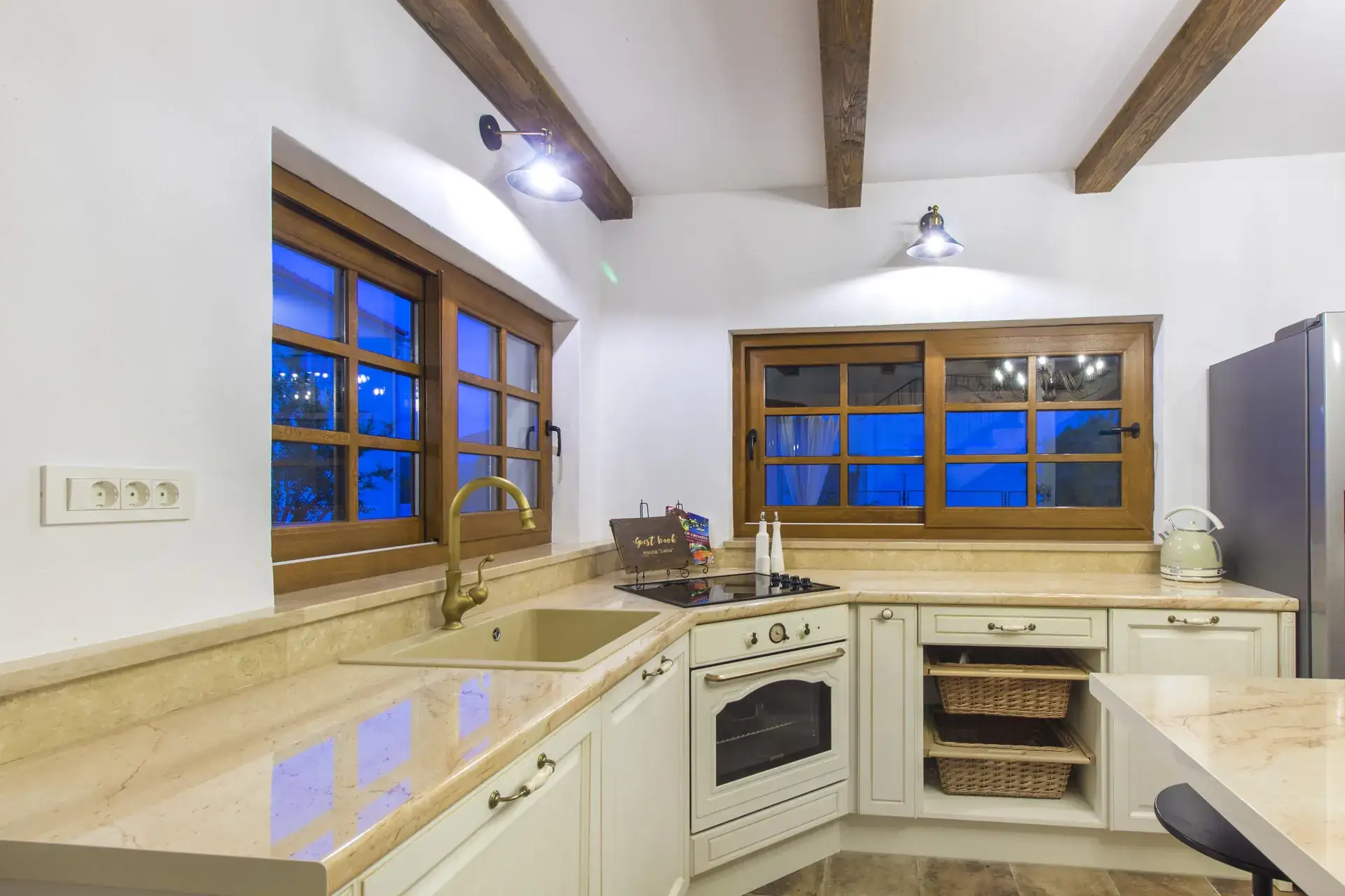 Corner kitchen with sink, oven and windows over the worktop