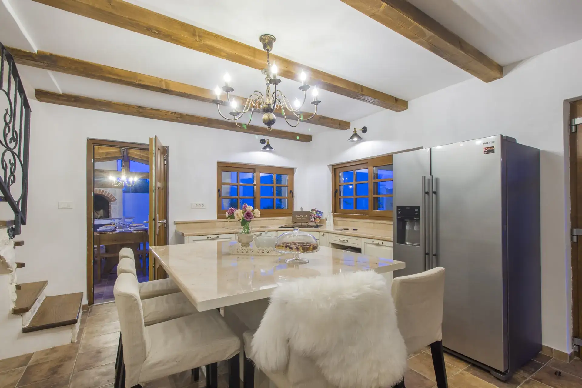 Kitchen island with seating for six and wooden ceiling beams