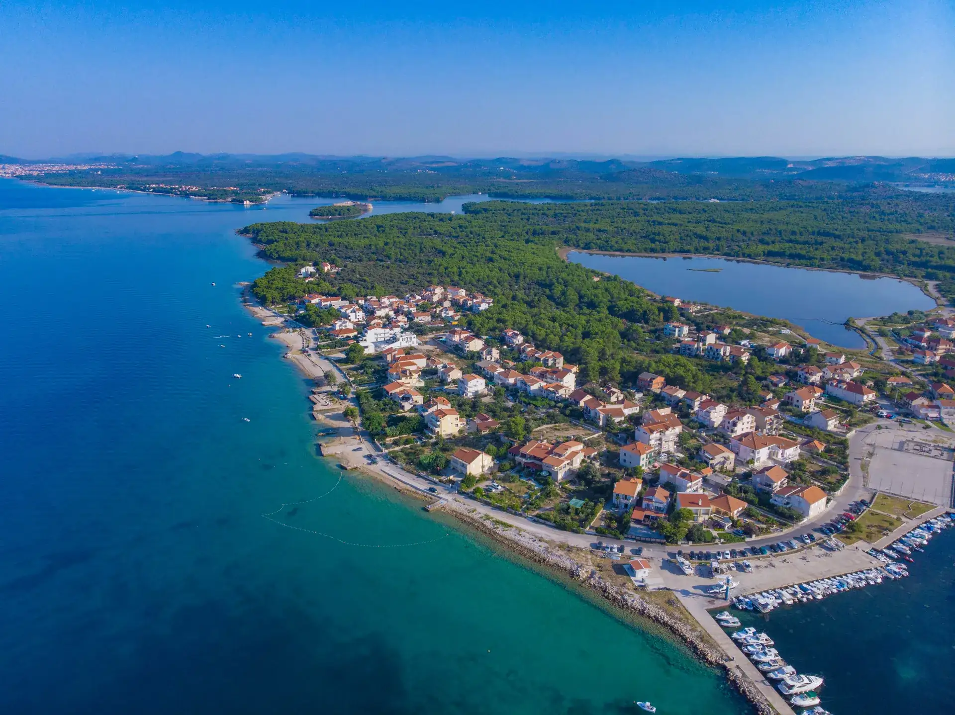 Aerial view of the Zablaće coastline with turquoise Adriatic water and the village beach