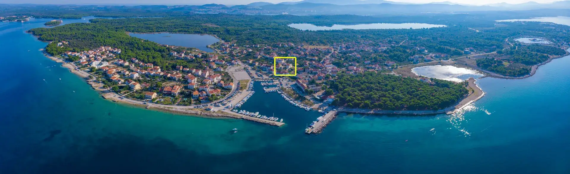 Panoramic aerial photo of Zablaće with House Leila marked, showing the harbour and the Adriatic coast